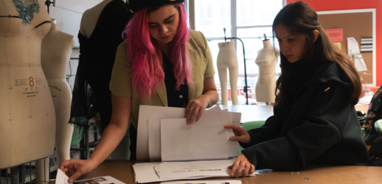 two designers working at a table